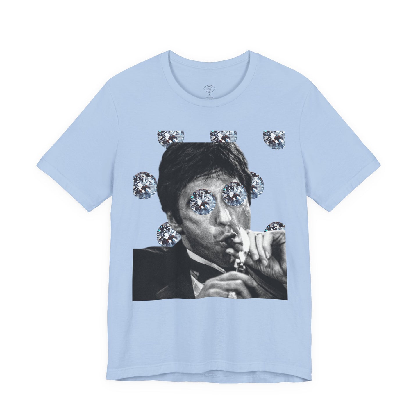 Light blue t-shirt with a graphic of a person with diamonds around their eyes on a white background