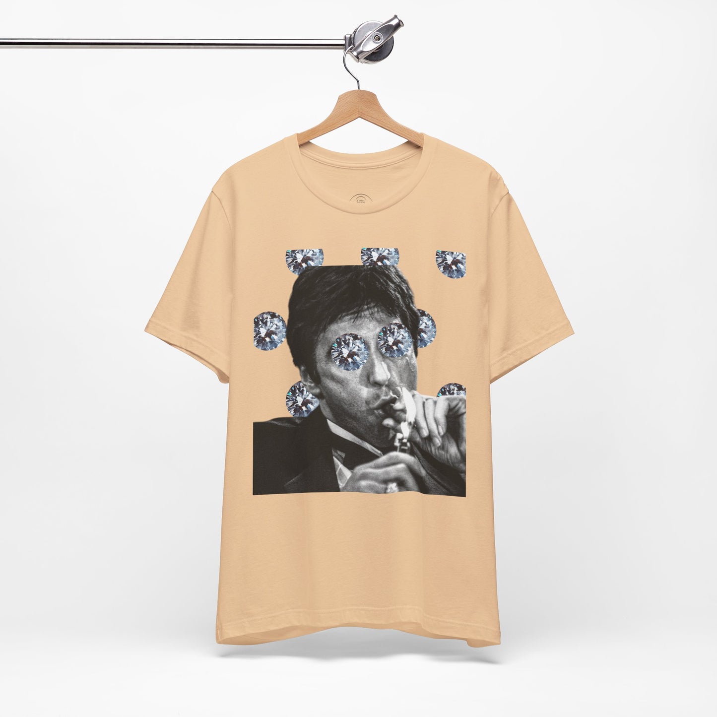 Beige t-shirt with a graphic of a person smoking and surrounded by diamonds on a hanger.